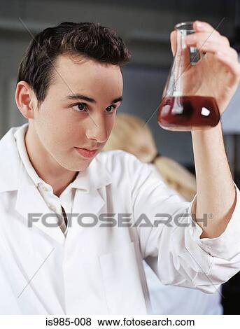 Stock Photo - Boy holding a volumeric flask. Fotosearch