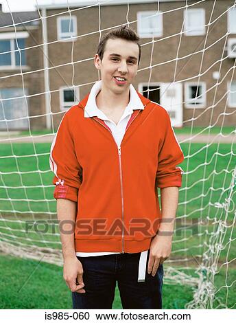 Stock Image - Boy standing in goal. Fotosearch