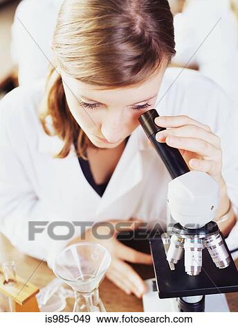 Girl looking in a microscope View Large Photo Image Stock Photo - Girl looking in a microscope. Fotosearch