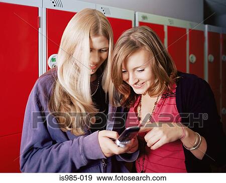 Girls looking at a text message View Large Photo Image Stock Photo - Girls looking at a text message. Fotosearch