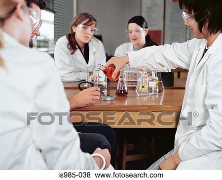 Stock Photo - Students doing an experiment. Fotosearch