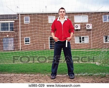 Stock Photo - Teenage boy standing in goal. Fotosearch