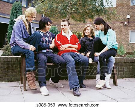 Teenagers on a bench View Large Photo Image Stock Photo - Teenagers on a bench. Fotosearch