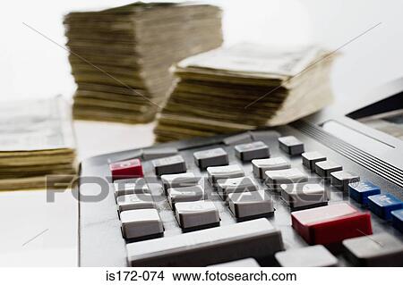Picture - Calculator and stacks of banknotes. Fotosearch