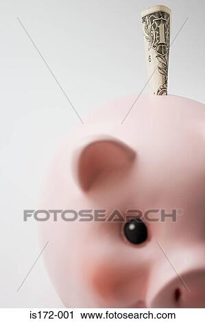 Stock Image - Dollar stuffed in a piggy bank. Fotosearch