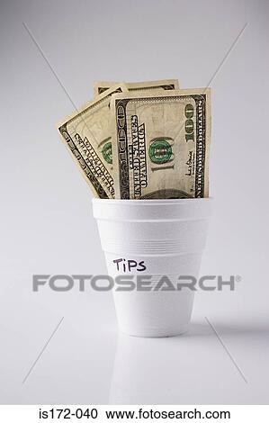 Stock Image - Hundred dollar bills in a tip cup. Fotosearch