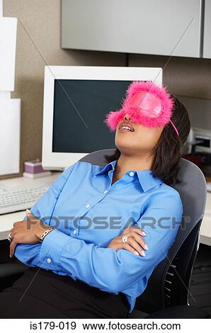 Stock Photo - Business woman sleeping at her desk. Fotosearch