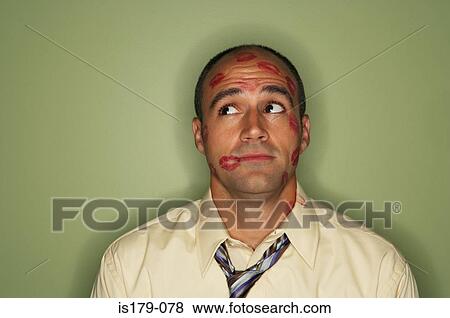 Stock Photo - Businessman covered in lipstick kisses. Fotosearch