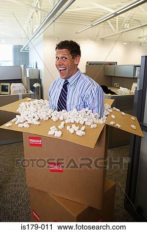 Stock Image - Businessman in cardboard box. Fotosearch