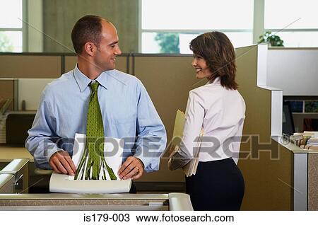 Stock Image - Businessman shredding his tie whilst looking away. Fotosearch