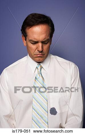 Stock Image - Businessman with ink stain on his shirt. Fotosearch