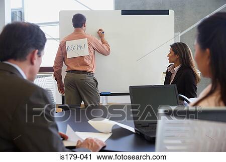 Businessman with sign on his back View Large Photo Image Stock Image - Businessman with sign on his back. Fotosearch