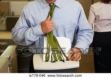 Stock Photograph - Businessman with tie caught in shredder. Fotosearch