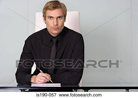 Businessman at his desk View Large Photo Image Stock Photo - Businessman at his desk. Fotosearch