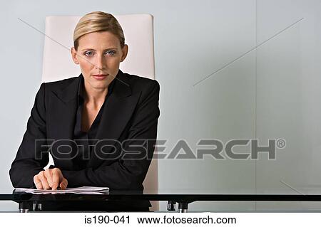 Businesswoman at her desk View Large Photo Image Stock Image - Businesswoman at her desk. Fotosearch