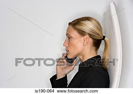 Picture - Businesswoman on mobile. Fotosearch