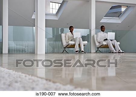Man and woman using laptops View Large Photo Image Stock Photo - Man and woman using laptops. Fotosearch