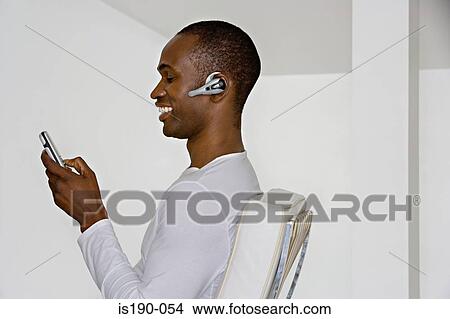 Man using hands free device View Large Photo Image Picture - Man using hands free device. Fotosearch