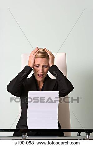 Stressed woman with paperwork View Large Photo Image Stock Photo - Stressed woman with paperwork. Fotosearch