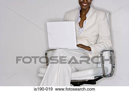Stock Photo - Stylish woman with laptop. Fotosearch