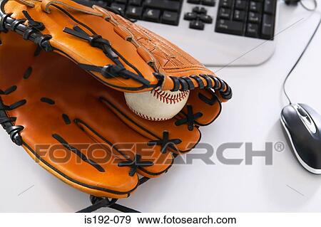 Baseball bat and glove on desk View Large Photo Image Stock Photo - Baseball bat and glove on desk. Fotosearch