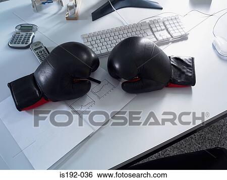 Boxing gloves on desk View Large Photo Image Stock Photograph - Boxing gloves on desk. Fotosearch