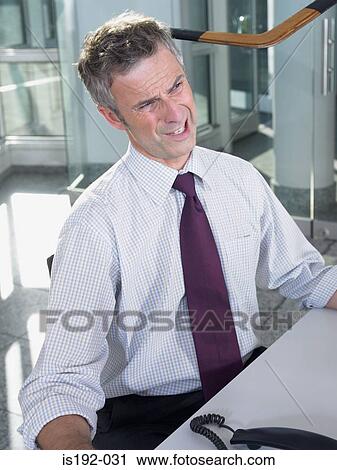 Stock Image - Businessman grimacing. Fotosearch