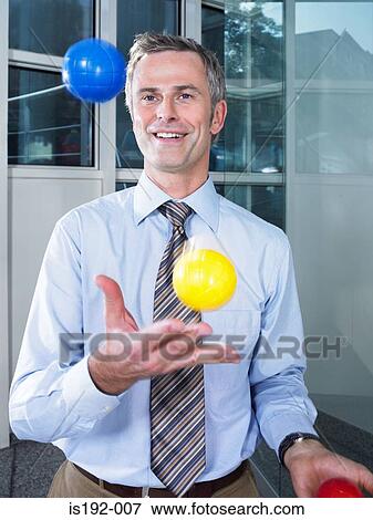 Stock Photo - Businessman juggling. Fotosearch