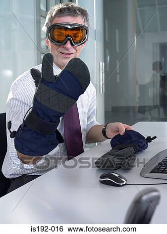 Stock Photograph - Businessman wearing ski goggles and gloves. Fotosearch
