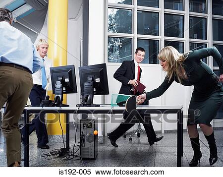 Stock Photography - Colleagues in table tennis game. Fotosearch