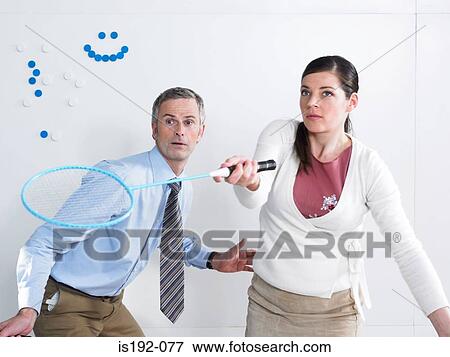 Stock Photo - Colleagues playing badminton. Fotosearch