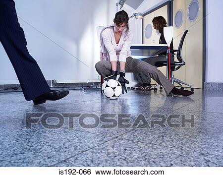 Stock Photograph - Colleagues playing football. Fotosearch