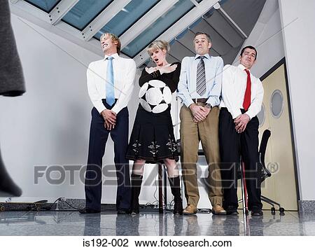 Kicking football at colleagues View Large Photo Image Stock Image - Kicking football at colleagues. Fotosearch