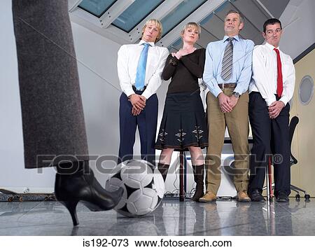 Kicking football at colleagues View Large Photo Image Stock Image - Kicking football at colleagues. Fotosearch