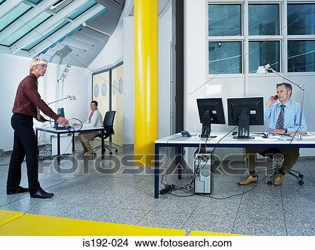 Man playing badminton in the office View Large Photo Image Picture - Man playing badminton in the office. Fotosearch
