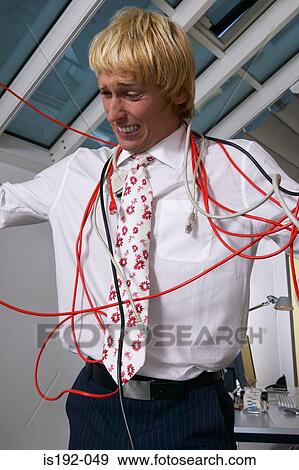 Stock Photo - Man tangled in cables. Fotosearch