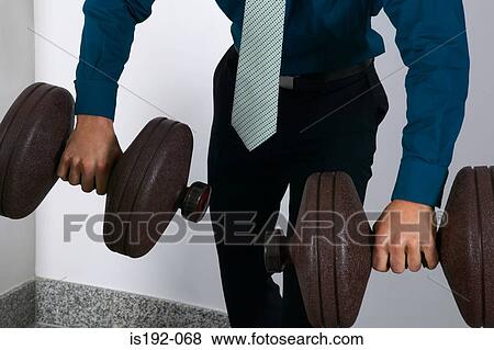 Office worker weightlifting View Large Photo Image Stock Photo - Office worker weightlifting. Fotosearch