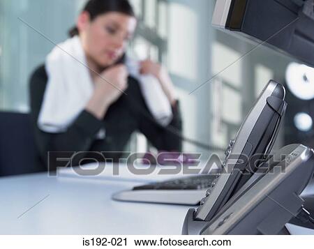 Stock Image - Woman at her desk. Fotosearch