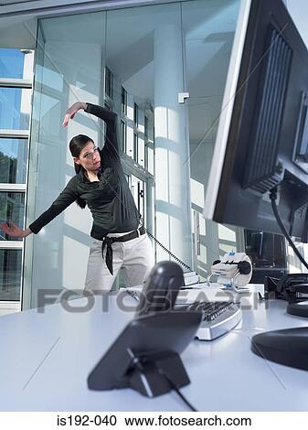 Woman on the phone and stretching View Large Photo Image Stock Image - Woman on the phone and stretching. Fotosearch