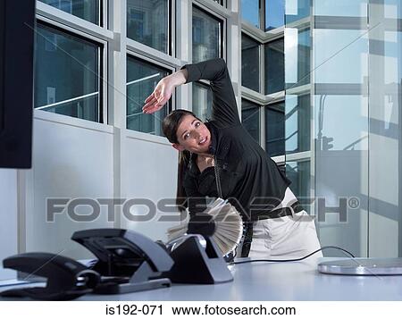 Woman on the phone and stretching View Large Photo Image Stock Image - Woman on the phone and stretching. Fotosearch