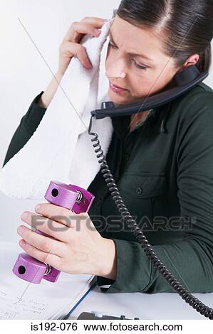 Woman on the phone using handgrip View Large Photo Image Stock Photograph - Woman on the phone using handgrip. Fotosearch