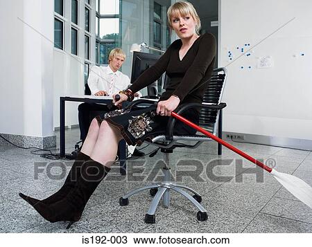 Stock Image - Woman rowing in office. Fotosearch