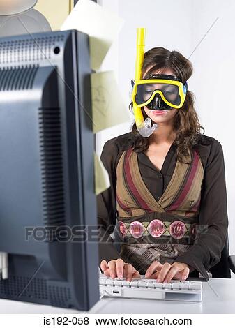 Woman wearing diving mask at desk View Large Photo Image Stock Photo - Woman wearing diving mask at desk. Fotosearch