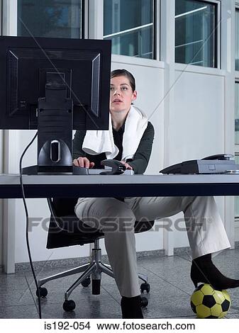 Woman with football under desk View Large Photo Image Picture - Woman with football under desk. Fotosearch