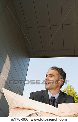 Stock Photograph - Businessman with financial newspaper. Fotosearch