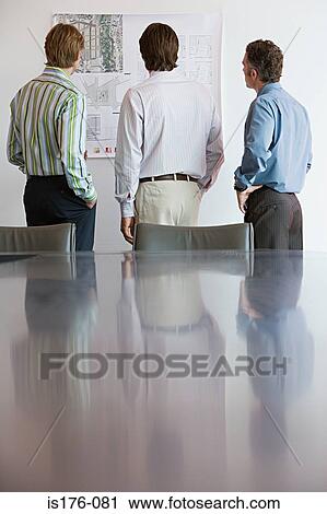 Businessmen looking at architectural plans View Large Photo Image Stock Image - Businessmen looking at architectural plans. Fotosearch