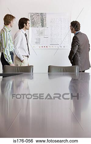 Businessmen looking at architectural plans View Large Photo Image Stock Photograph - Businessmen looking at architectural plans. Fotosearch