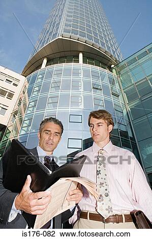 Stock Image - Businessmen outside office. Fotosearch