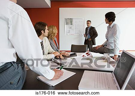 Stock Photograph - Businesspeople discussing plans. Fotosearch