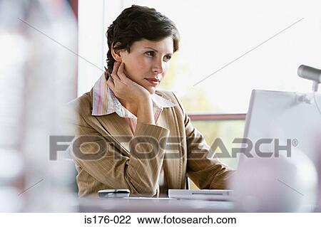 Businesswoman at her desk View Large Photo Image Stock Image - Businesswoman at her desk. Fotosearch